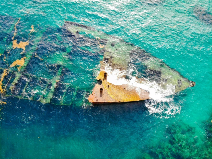 a boat that is sitting in the water, pexels contest winner, remnants of old spaceship, taking from above, te pae, striking colour