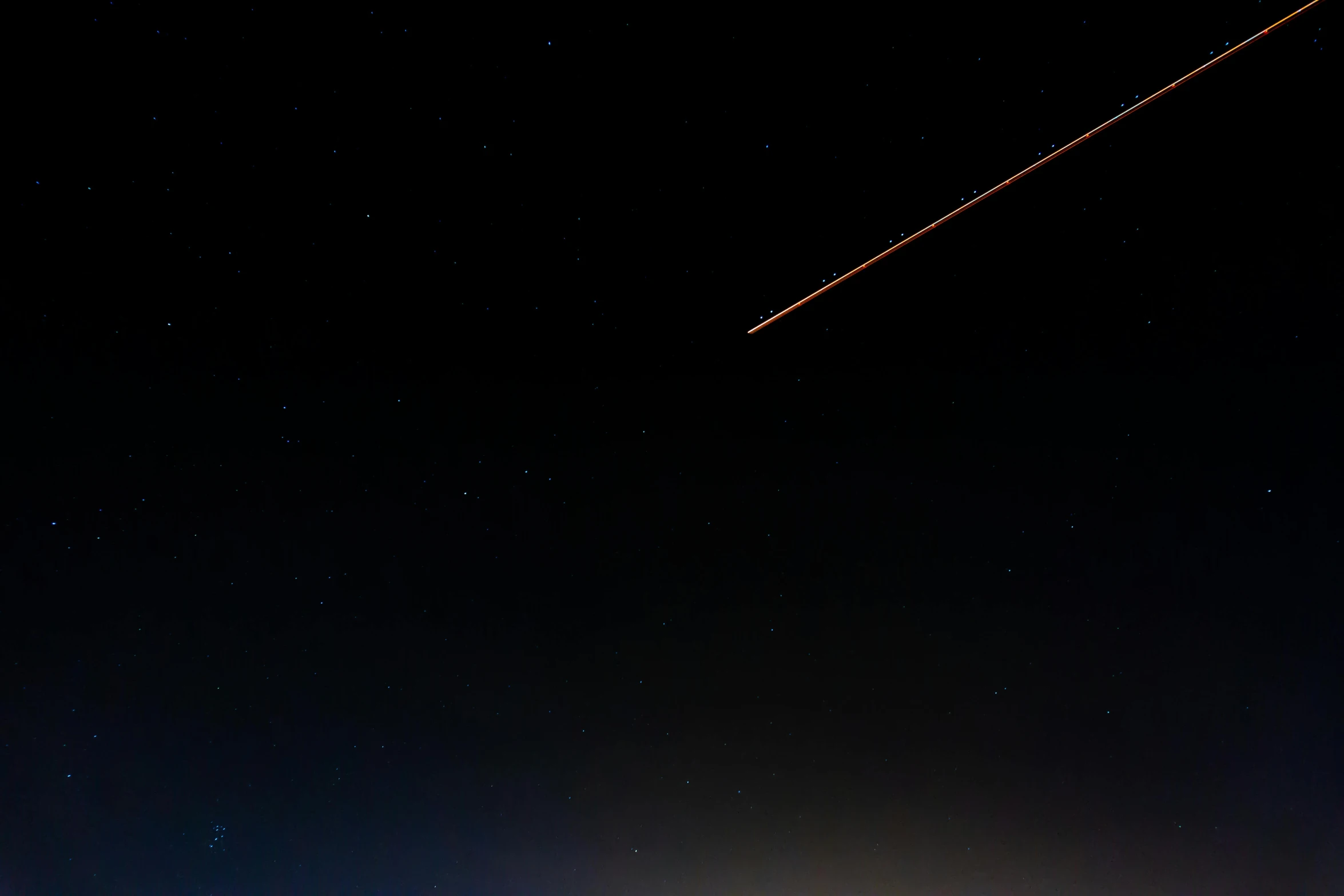 a plane flying over a city at night, by Niko Henrichon, pexels, space art, perseides meteor shower, brown, blue fireball, rectangle