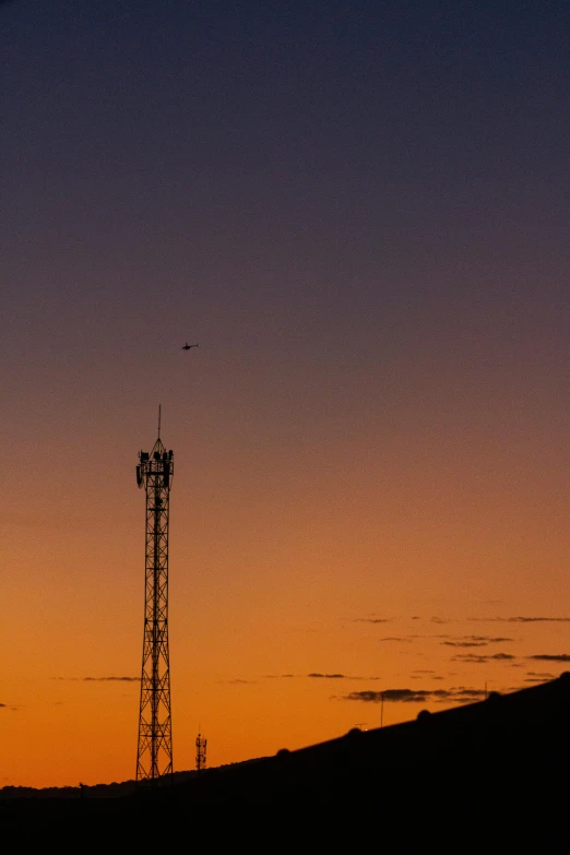 a very tall tower sitting on top of a hill, by Peter Churcher, minimalism, antenna, flying through sunset, square, low iso