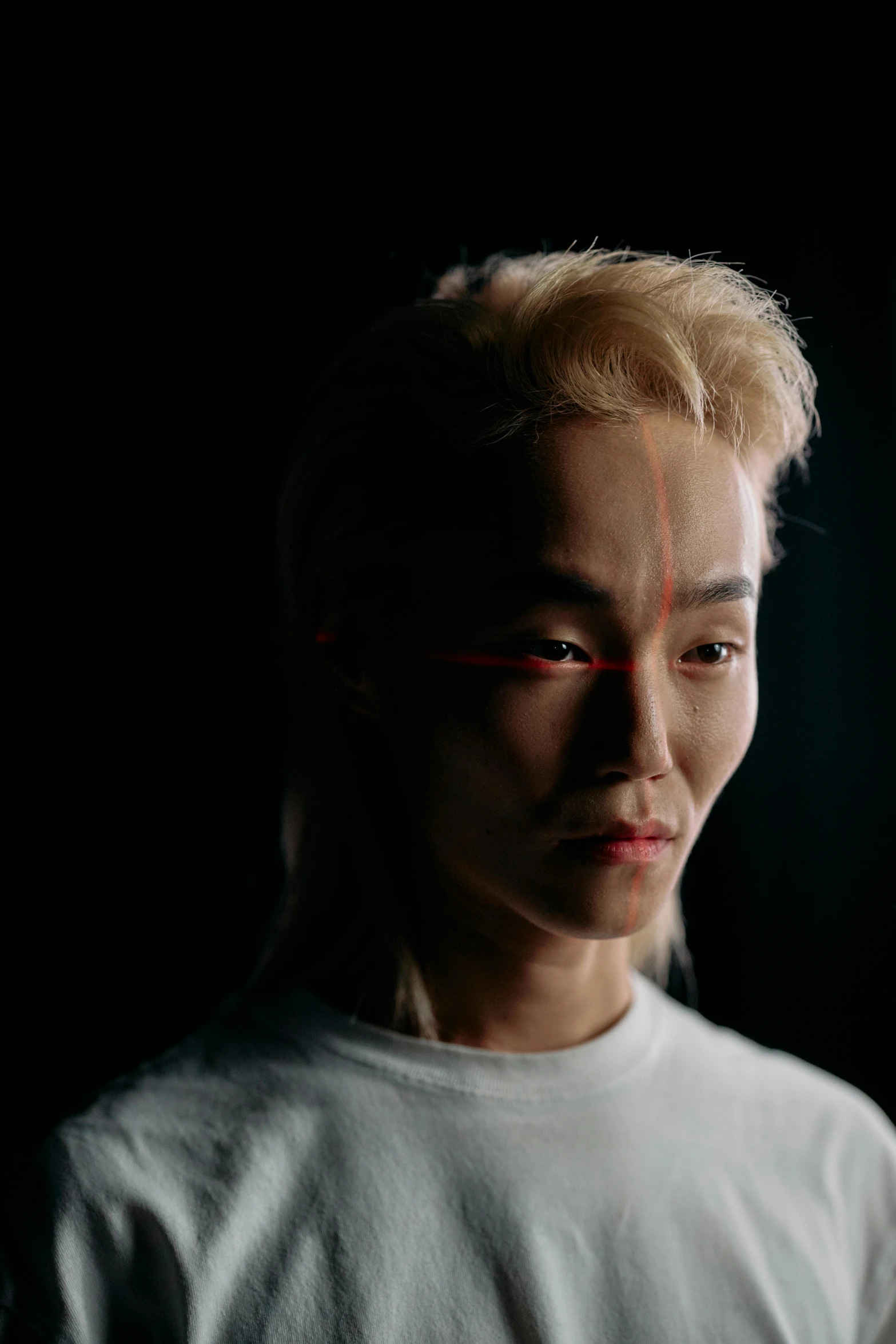 a close up of a person with a cell phone, an album cover, inspired by jeonseok lee, trending on pexels, hyperrealism, attractive androgynous humanoid, red led eyes, photographed for reuters, spotlight from face