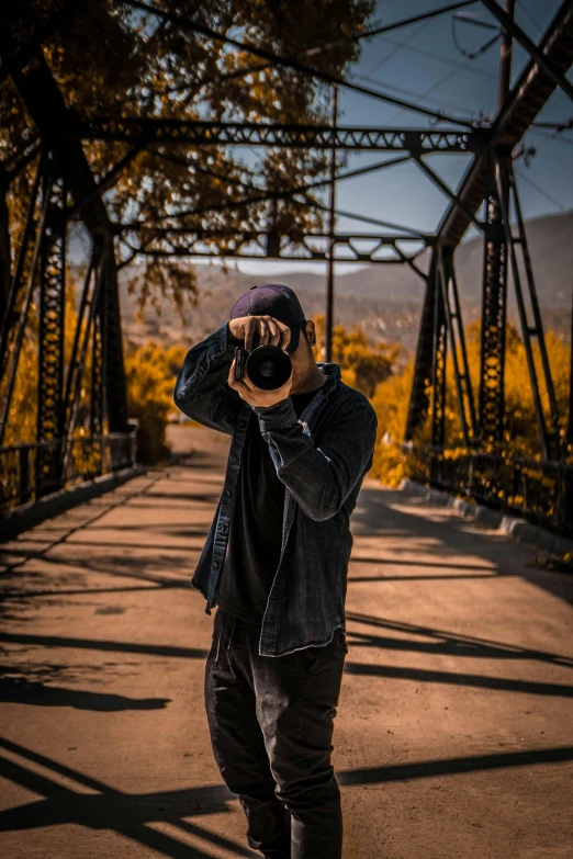 a man taking a picture of himself on a bridge, a picture, pexels contest winner, full body in camera, headshot profile picture, fall season, industrial photography