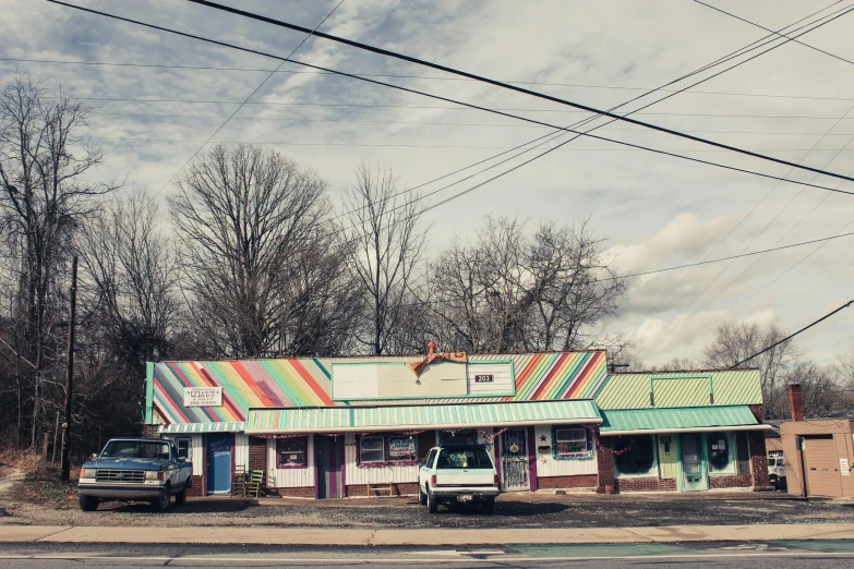 a store sitting on the side of a road, a portrait, by Dan Frazier, unsplash, candy pastel, riverdale, corduroy road, multi colored