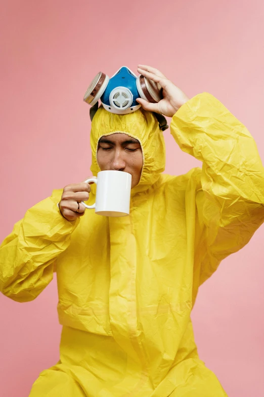 a man in a yellow rain suit drinking from a cup, inspired by Wes Anderson, trending on unsplash, plasticien, made of lab tissue, biohazard, upset the coffee does not work, 2019 trending photo