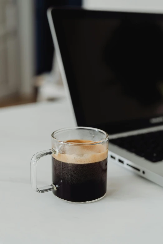 a cup of coffee next to a laptop, no cropping, vantablack, curated collections, multiple stories