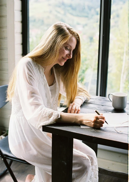 a woman sitting at a table writing on a piece of paper, by Sara Saftleven, pexels contest winner, white tunic, attractive girl, gif, full mood