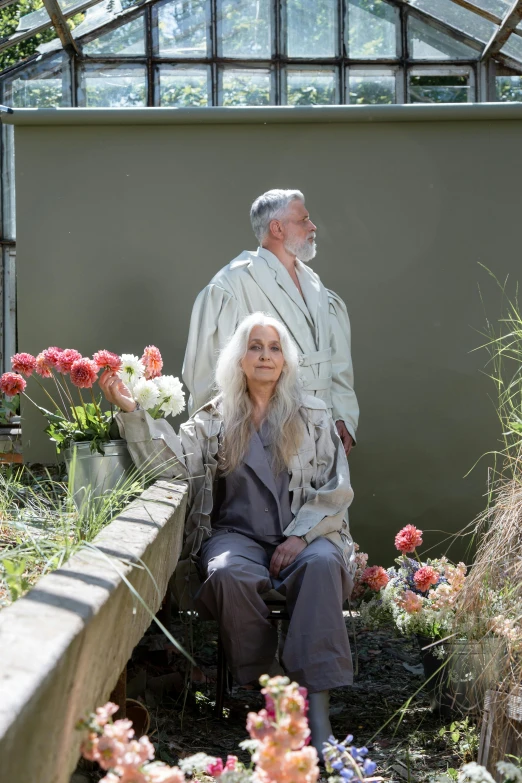 a man and a woman sitting in a greenhouse, a portrait, unsplash, renaissance, long silver hair with a flower, herman nitsch and herman nitsch, grey robes, vivienne westwood