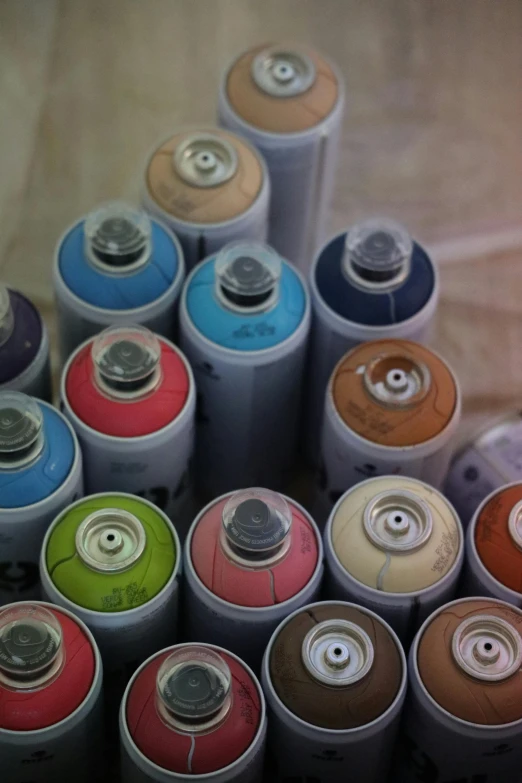 a pile of batteries sitting on top of a table, an airbrush painting, by artist, graffiti, multicolor, multicolored, cans, pantone