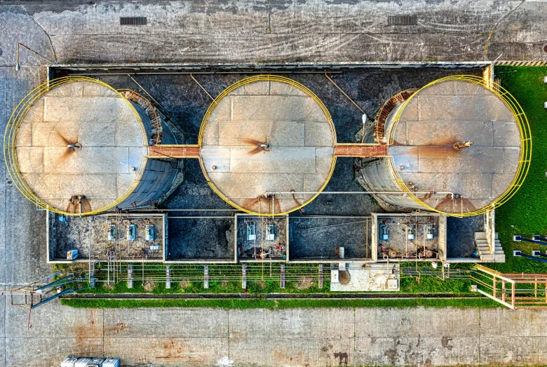 a couple of large tanks sitting next to each other, by Jan Rustem, pexels contest winner, renaissance, satellite imagery, valves, drone photo, wear and tear