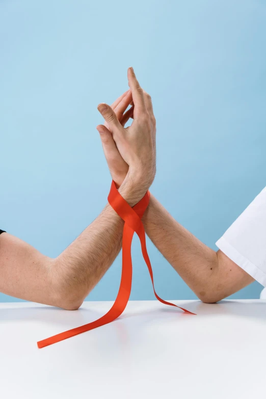 a pair of hands tied together with a red ribbon, trending on reddit, limb mutations, facing each other, hands on counter, nursing