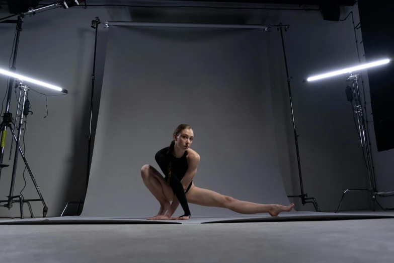 a woman in a leo leo leo leo leo leo leo leo leo leo leo leo leo leo, inspired by Elizabeth Polunin, unsplash, photorealism, curved. studio lighting, athletic footage, 35 mm product photo”, doing splits and stretching
