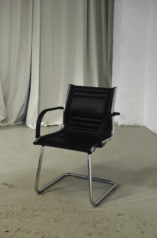 a black office chair sitting in front of a curtain, by Carlo Martini, morhbacher, vintage!, black, universal