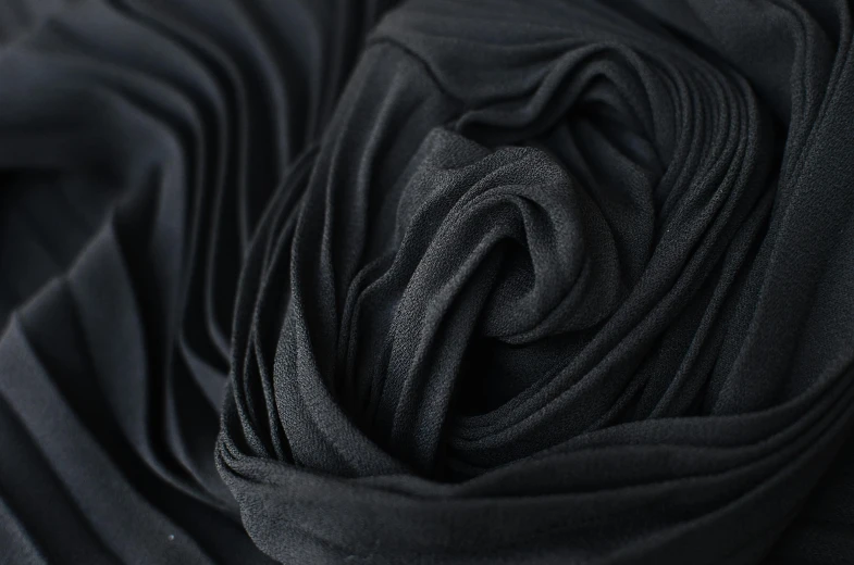 a close up view of a black fabric, a macro photograph, inspired by Pierre Soulages, unsplash, chiffon, black, spiralling, main colour - black