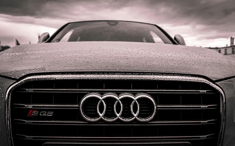 a close up of a car with a cloudy sky in the background, a stipple, by Adam Marczyński, pexels contest winner, audi a4 b6 avant (2002), foam, hydrogen fuel cell vehicle, well built