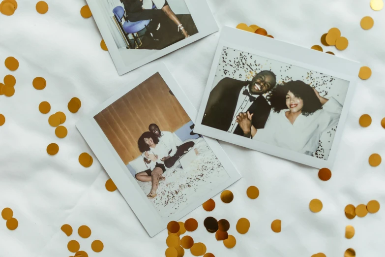 three polaroids sitting on top of a bed covered in gold confetti, a polaroid photo, pexels contest winner, sza, wearing a white tuxedo, couple on bed, filling the frame