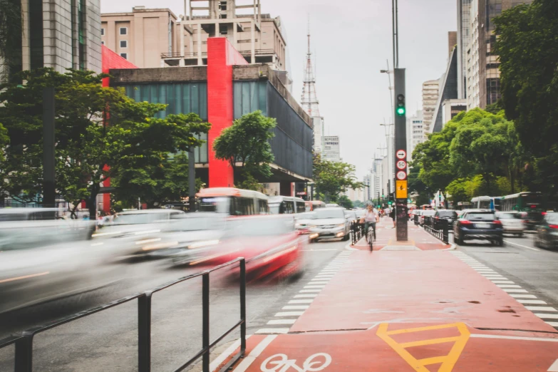 a street filled with lots of traffic next to tall buildings, by Ceferí Olivé, pexels contest winner, visual art, sao paulo in the year 2 0 7 0, red building, sport, university