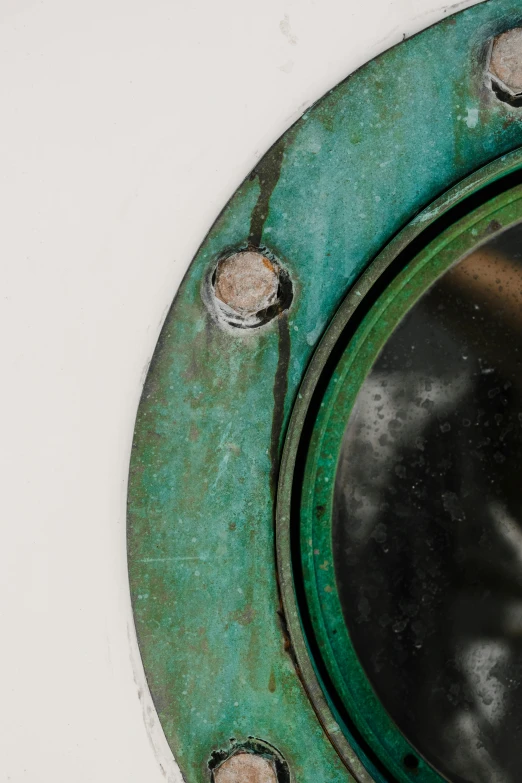 a close up of a mirror on a wall, by Jan Tengnagel, copper and emerald, submarine camera imagery, weathered, detailed product image