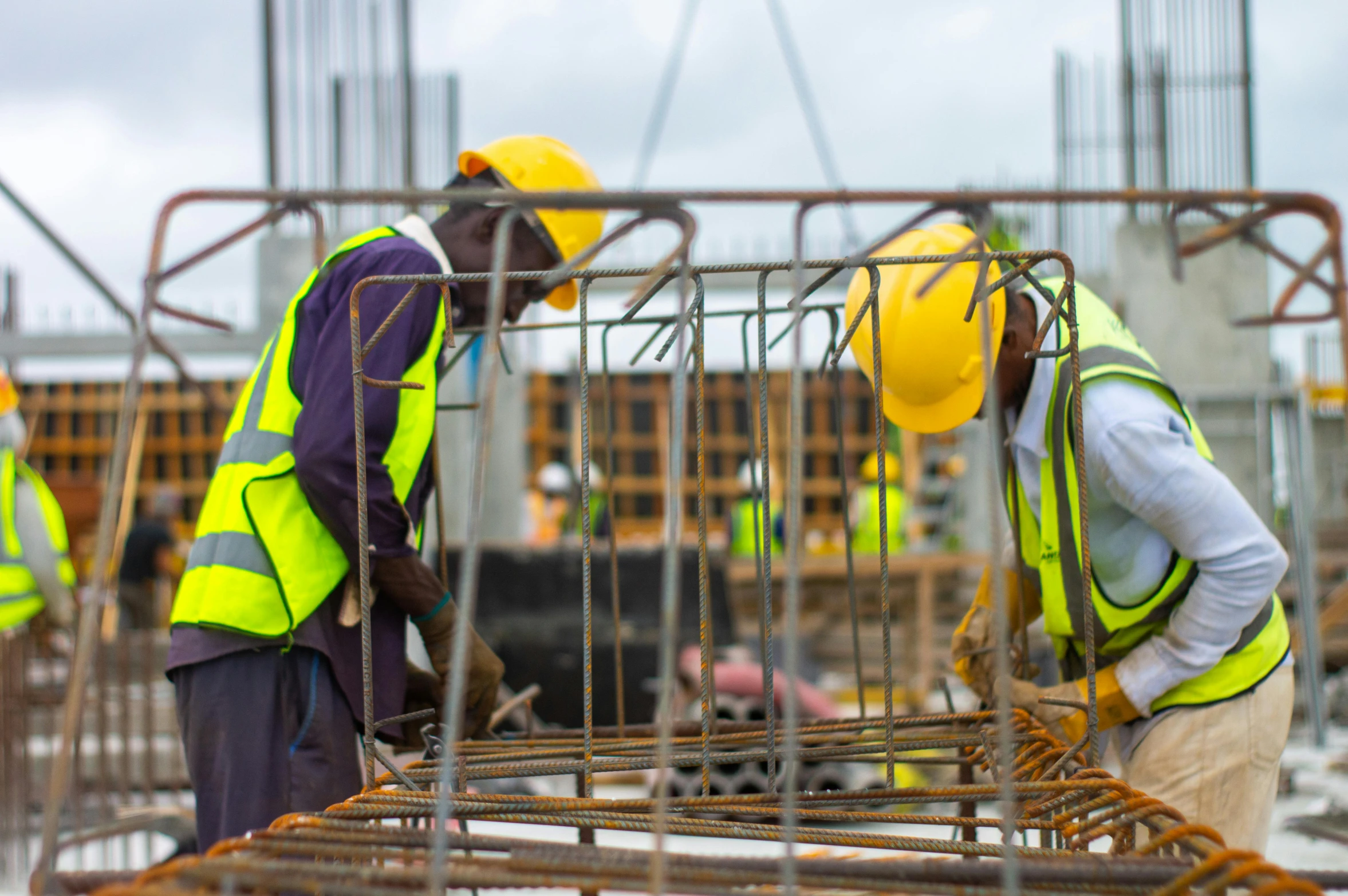 a group of men working at a construction site, by Malvin Gray Johnson, pexels contest winner, somalia, wearing hi vis clothing, avatar image, close - up photo