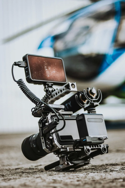 a close up of a camera with a helicopter in the background, by Tom Bonson, unsplash, video art, arri alexa mini lf, full body profile camera shot, android close to camera, intricate cinematic light