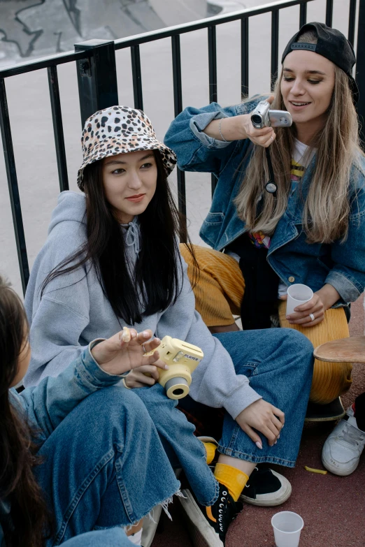 a group of young people sitting next to each other, trending on pexels, realism, yellow cap, korean women's fashion model, lomography lady grey, juice