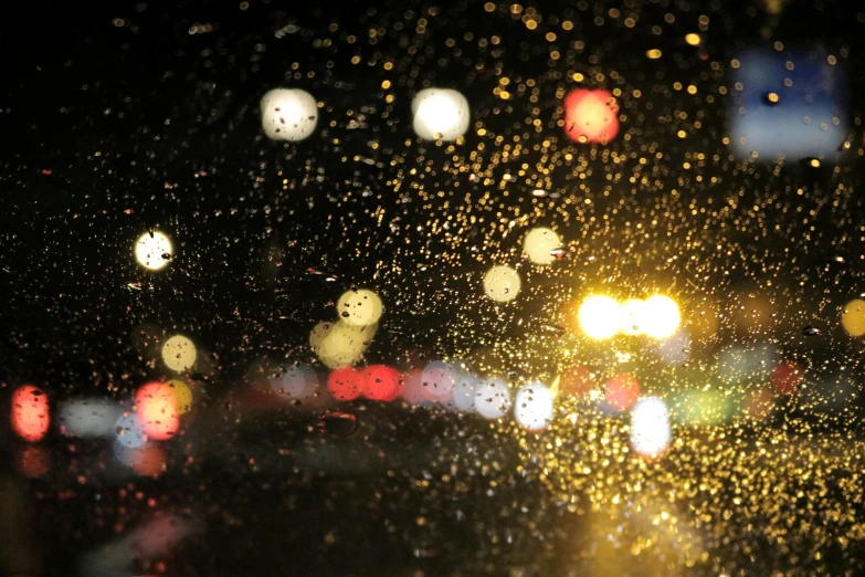a blurry photo of a city street at night, a picture, unsplash, hurufiyya, raindrops, close - up photo, shot on sony a 7, car shot