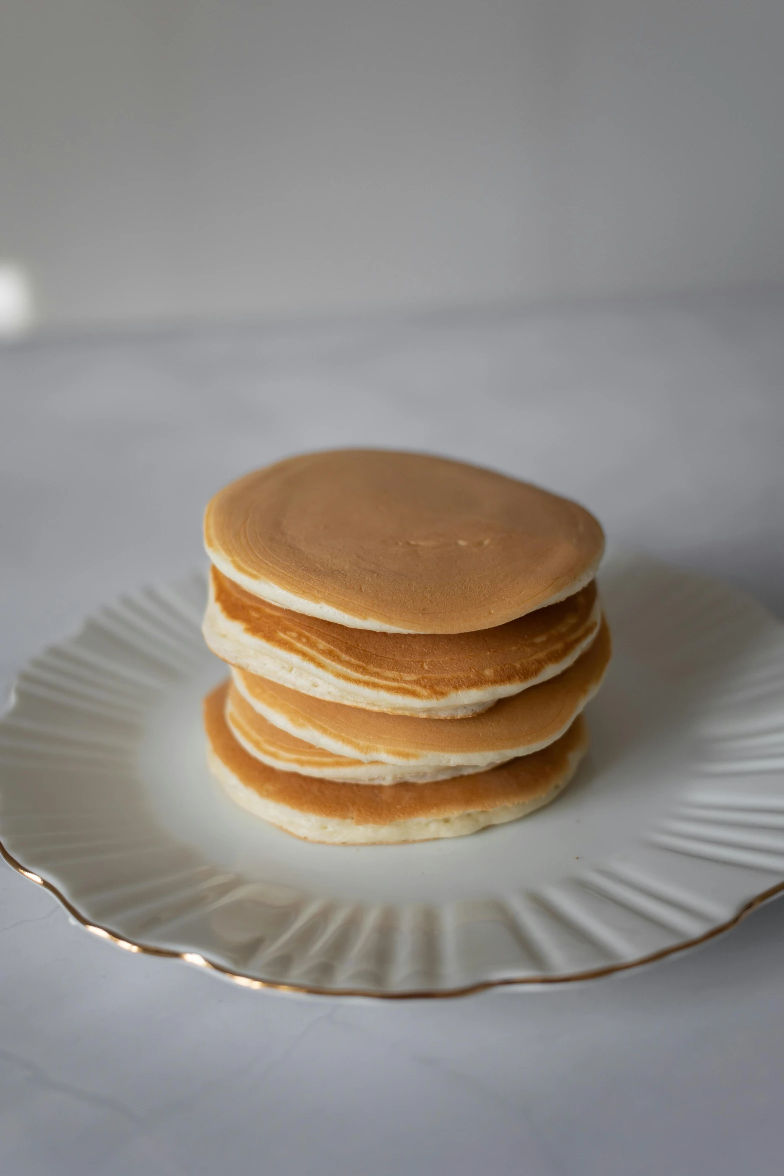 a stack of pancakes sitting on top of a white plate, product image, 3/4 front view, mini, soft skin