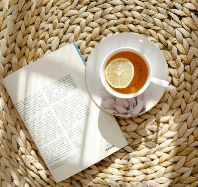a cup of tea next to an open book, pexels contest winner, light boho carpet, lemon, thumbnail, round format