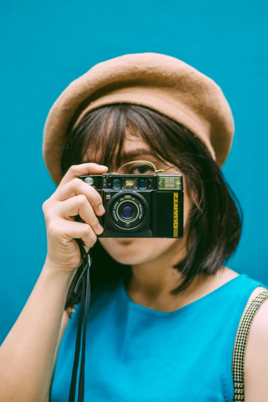 a woman taking a picture with a camera, inspired by Yuko Tatsushima, blue and yellow color theme, photography], vivid)