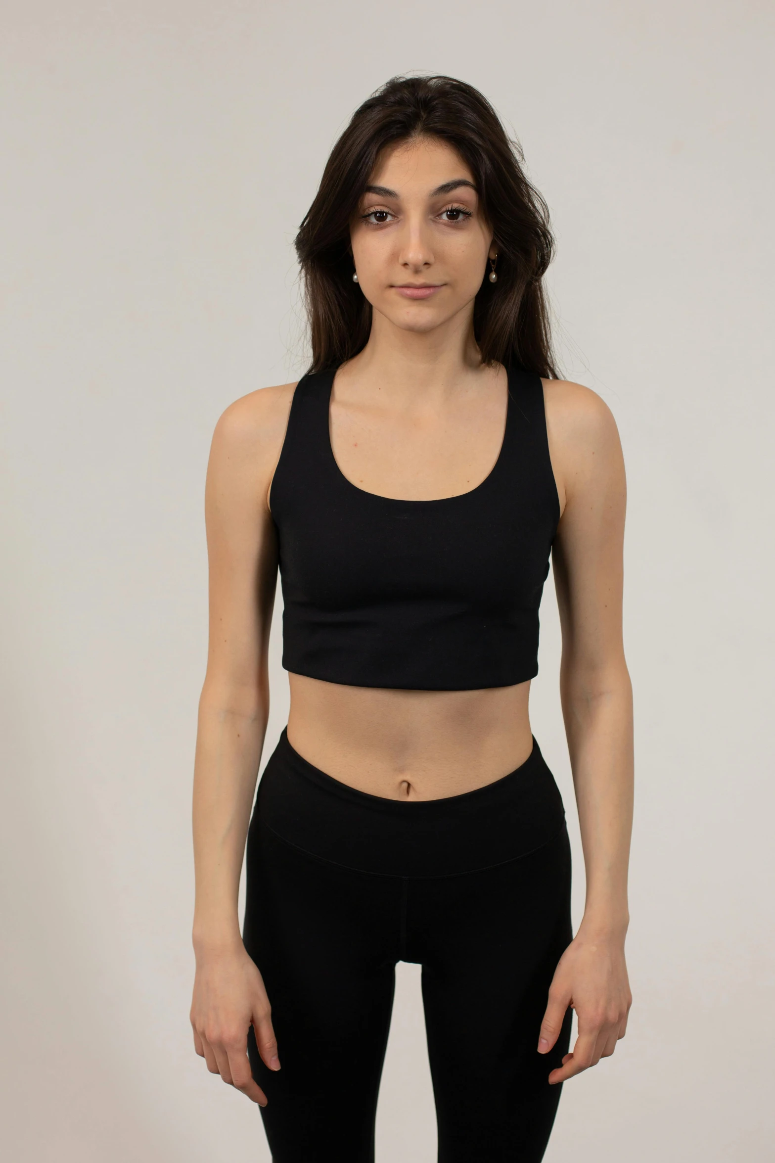 a woman in a black sports bra top and black leggings, inspired by Kanō Tan'yū, reddit, wearing a cropped top, a middle-shot from front, 5 0 0 px models, upscaled to high resolution