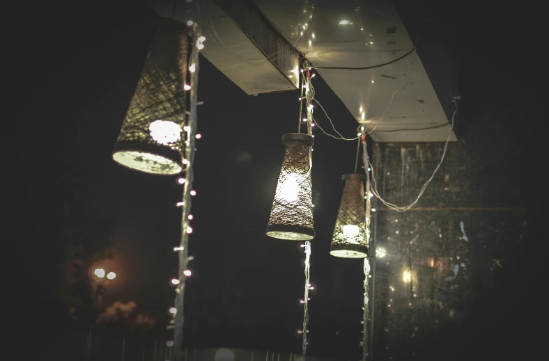 a bunch of lights hanging from a ceiling, unsplash, lanterns on the porch, light cone, atmospheric lighting - n 9, experimental studio light