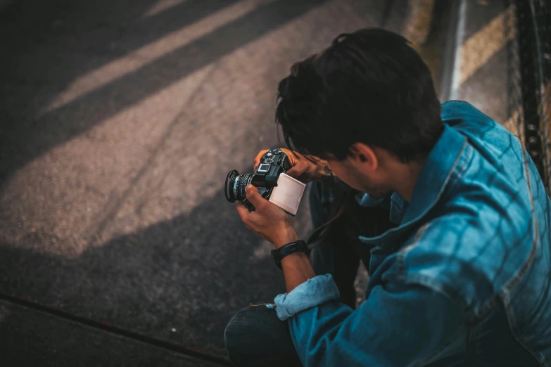 a man taking a picture with a camera, pexels contest winner, looking down on the camera, professional color photography, casual photography, foreshortening photography