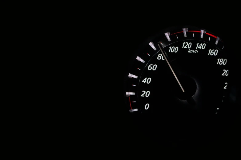 a close up of a speedometer in the dark, an album cover, unsplash, visual art, racing, getty images, octane - render, sitting in ten forward