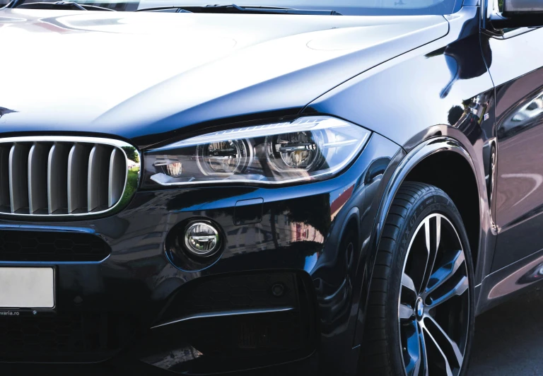 a black bmw suv parked in a parking lot, pexels contest winner, photorealism, headlight washer, extremely polished, thumbnail, professional closeup photo