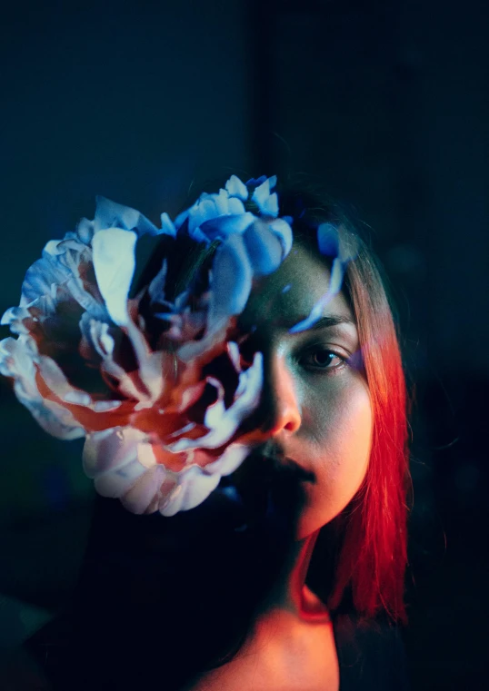 a woman with a flower in her hair, inspired by Elsa Bleda, pexels contest winner, red and blue lighting, avatar image, overexposed, large)}]