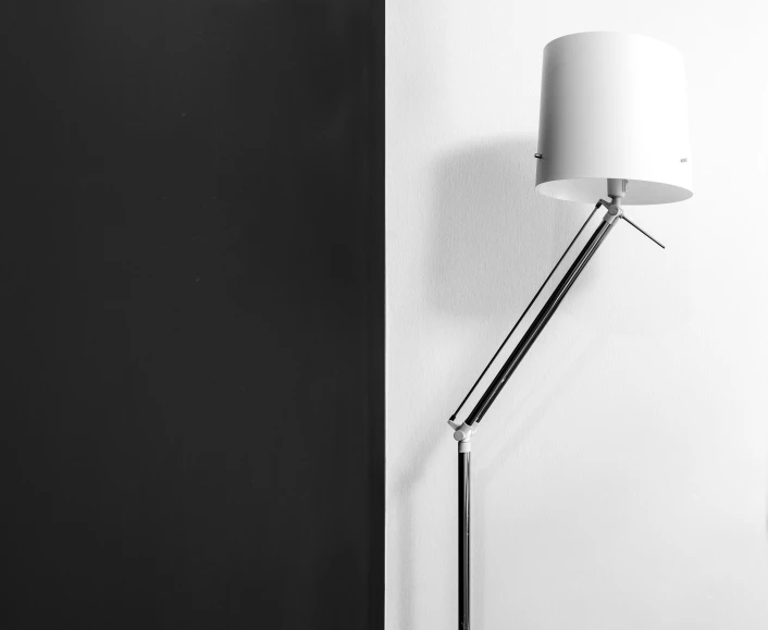 a black and white photo of a lamp on a wall, inspired by Robert Mapplethorpe, pexels contest winner, floor lamps, two tone, vantablack wall, elegant asymmetrical