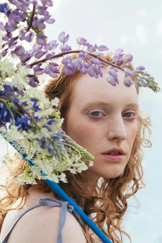 a woman with a bunch of flowers on her head, by Carey Morris, trending on pexels, renaissance, a redheaded young woman, blue and violet, liberty curls, ignant