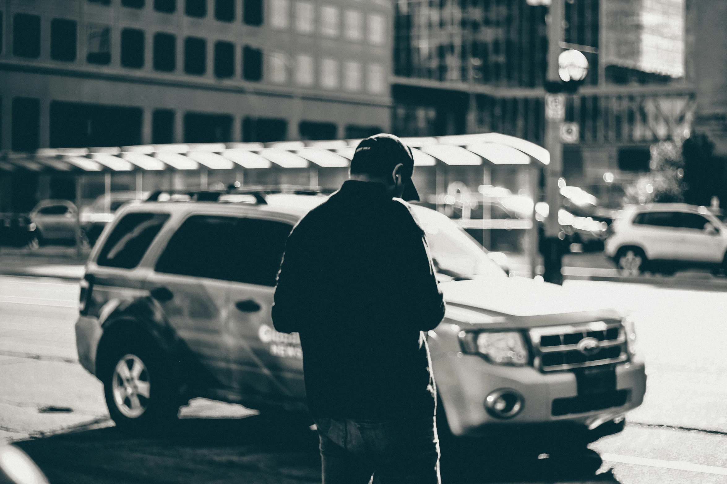 a man standing next to a parked car on a city street, pexels contest winner, cold, highcontrast, people at work, taxis