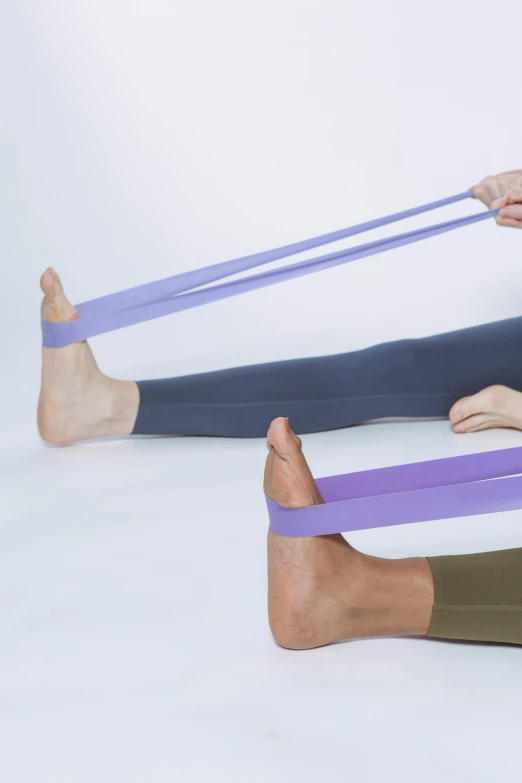 a man and a woman doing a yoga pose, dribble, purple ribbons, low detail, square, press photography