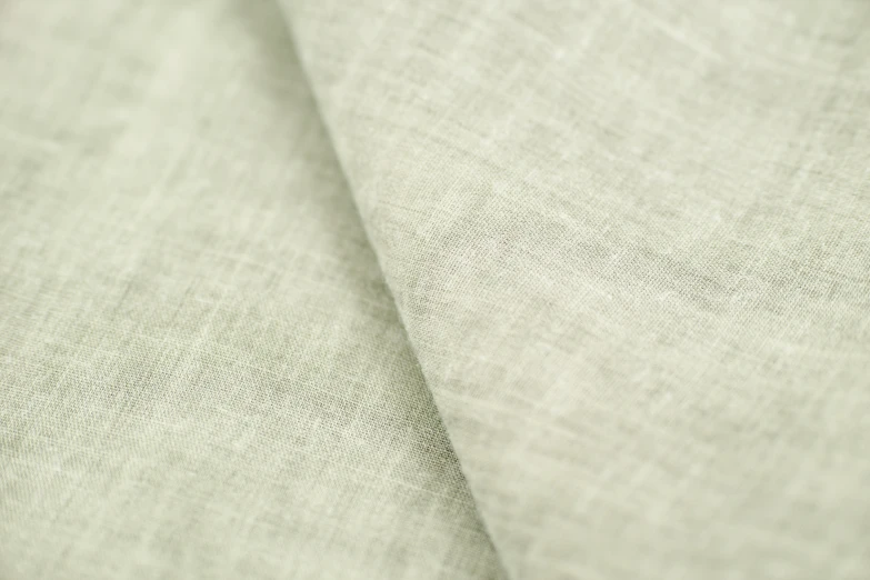 a close up of a piece of linen, light green mist, up close image