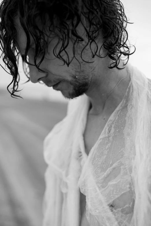 a black and white photo of a man with wet hair, by Jan Tengnagel, young tom hiddleston, wearing white cloths, edd cartier, tattered clothes