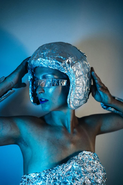 a woman covered in tin foil posing for a picture, inspired by hajime sorayama, unsplash, afrofuturism, glowing eyes in helmet, studio photo, covered in bandages, singularity sculpted �ー etsy