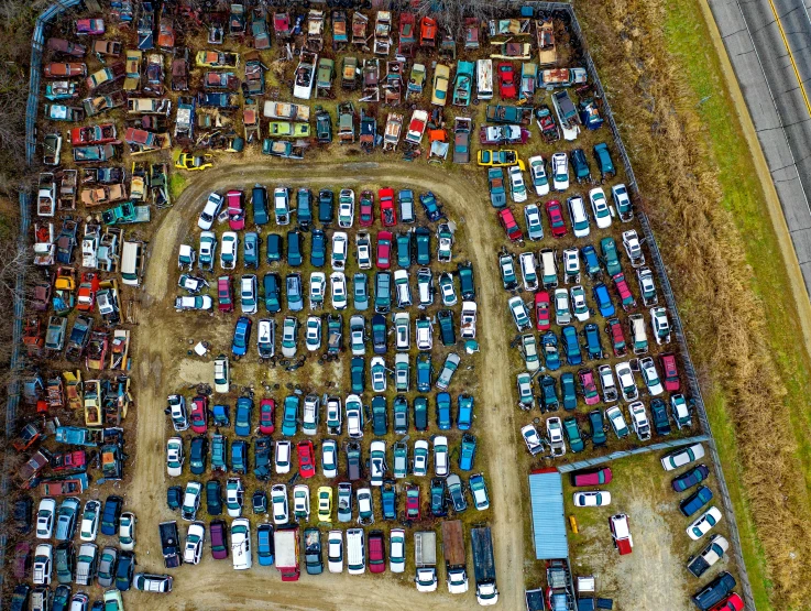 a parking lot filled with lots of parked cars, by Daniel Lieske, unsplash, auto-destructive art, mining scrap metal, square, multi - coloured, aerial footage