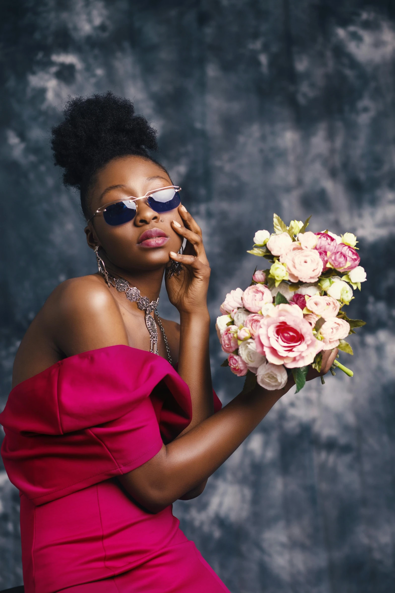 a woman in a pink dress holding a bouquet of flowers, by Chinwe Chukwuogo-Roy, trending on pexels, romanticism, with sunglass, lupita nyong'o, concept photo, black young woman