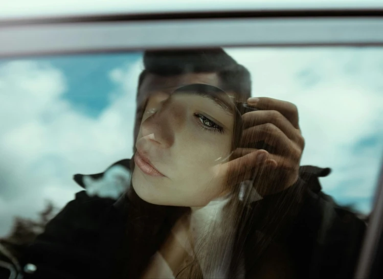 a woman sitting in a car talking on a cell phone, a picture, inspired by Elsa Bleda, trending on pexels, hyperrealism, sad man, person made out of glass, showing forehead, embracing