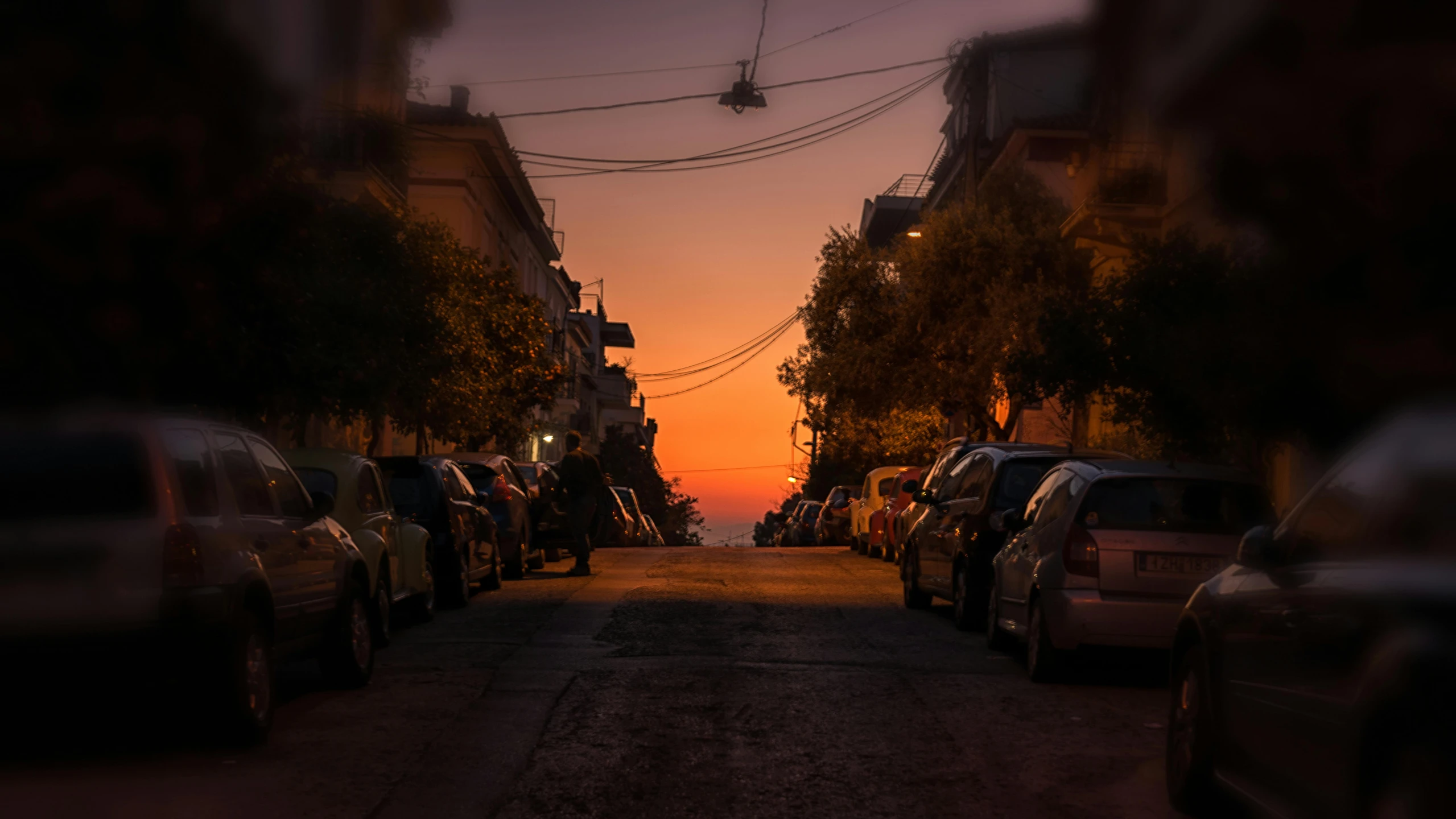 a street filled with lots of parked cars, by Michalis Oikonomou, pexels contest winner, hyperrealism, sunset panorama, square, greek, shot on sony a 7