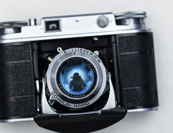 a close up of a camera with a person in the lens, inspired by Vivian Maier, art photography, olympus, collectible, 1940's photography, 4 5 mm