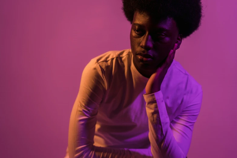 a man in a white shirt posing for a picture, an album cover, by Winona Nelson, pexels contest winner, afrofuturism, barely lit warm violet red light, soft light 4 k in pink, model posing, second colours - purple