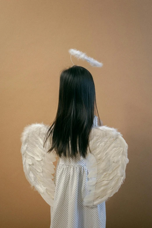 a little girl dressed up as an angel, an album cover, pexels contest winner, conceptual art, a young asian woman, faceless, 15081959 21121991 01012000 4k, plain background