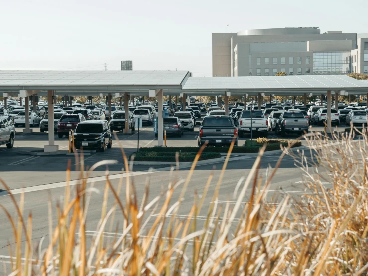 a parking lot filled with lots of cars, a picture, by Carey Morris, unsplash, happening, hospital in background, idaho, pentagon, heavy lines