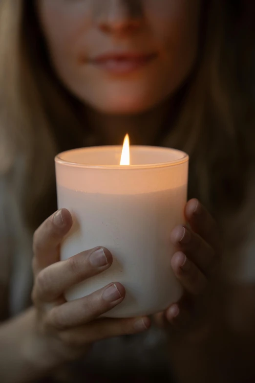 a woman holding a lit candle in her hands, profile image, environmental shot, ivory, ultradetailed