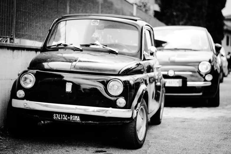 a couple of cars parked next to each other on a street, a black and white photo, by Sven Erixson, unsplash, renaissance, alfa romeo project car, detailed medium format photo, in 2 0 1 2, portrait!!!!